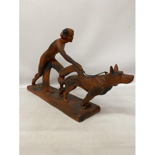 38 - AN ART DECO TERRACOTTA FIGURE OF A LADY AND HOUND 29