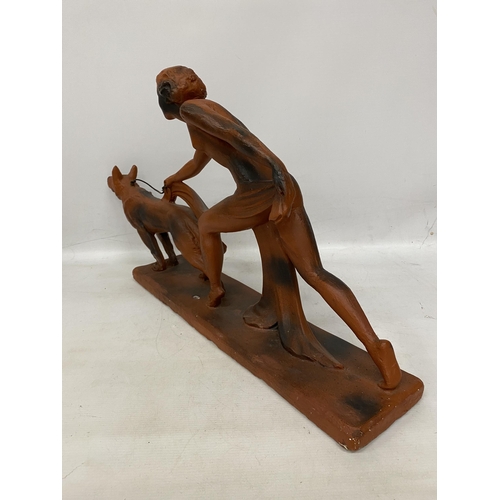 38 - AN ART DECO TERRACOTTA FIGURE OF A LADY AND HOUND 29