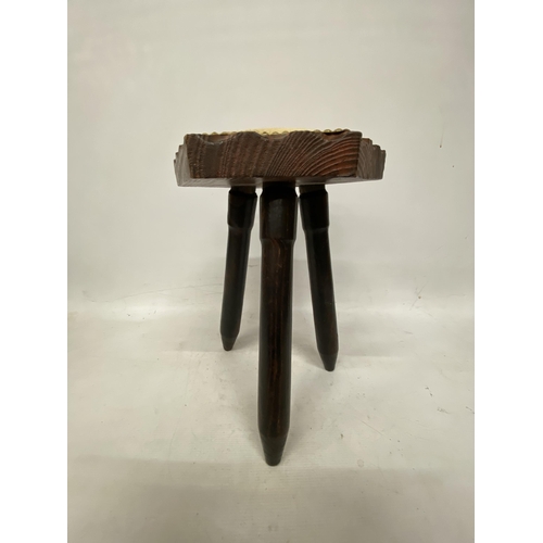 67 - A THRRE LEGGED MILKING STOOL WITH COW HIDE SEAT HEIGHT 41CM