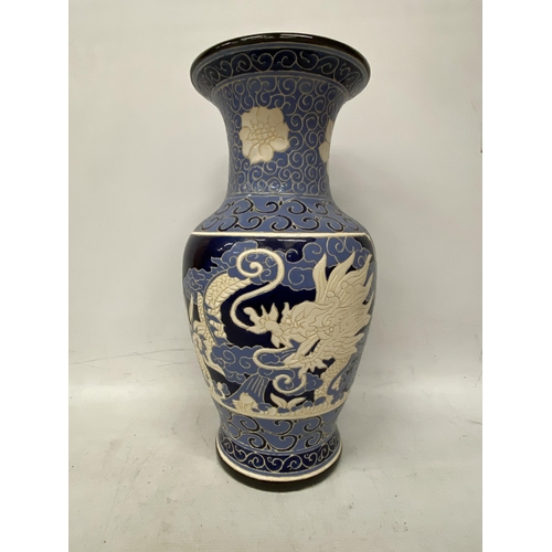 69 - A LARGE BLUE AND CREAM GLAZED CHINOISERIE VASE HEIGHT 53CM