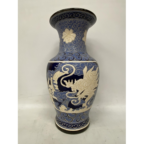 69 - A LARGE BLUE AND CREAM GLAZED CHINOISERIE VASE HEIGHT 53CM