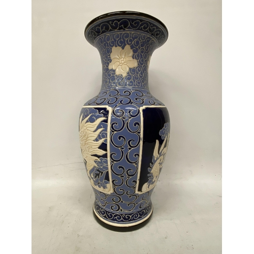 69 - A LARGE BLUE AND CREAM GLAZED CHINOISERIE VASE HEIGHT 53CM