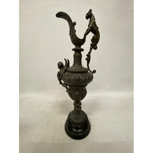 87 - A PAIR OF CAST DECORATIVE EWERS WITH CHERUBS ON A BASES HEIGHT 54CM