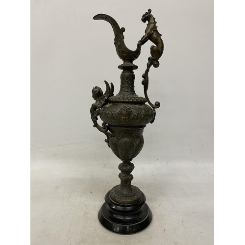 87 - A PAIR OF CAST DECORATIVE EWERS WITH CHERUBS ON A BASES HEIGHT 54CM