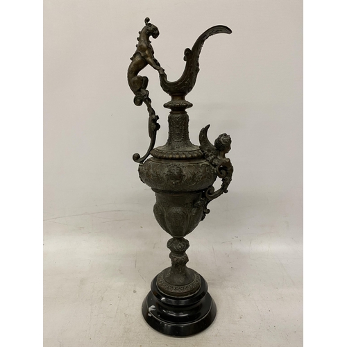 87 - A PAIR OF CAST DECORATIVE EWERS WITH CHERUBS ON A BASES HEIGHT 54CM