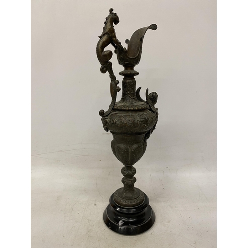 87 - A PAIR OF CAST DECORATIVE EWERS WITH CHERUBS ON A BASES HEIGHT 54CM