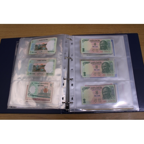 305 - A FOLDER CONTAINING IN EXCESS OF 100 VINTAGE WORLD BANK NOTES TO INCLUDE THE CENTRAL BANK OF EGYPT 5... 