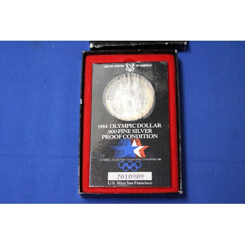 423 - A 1984 OLYMPIC COIN .900 SILVER IN A PRESENTATION BOX