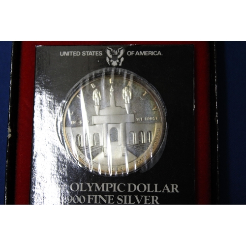 423 - A 1984 OLYMPIC COIN .900 SILVER IN A PRESENTATION BOX