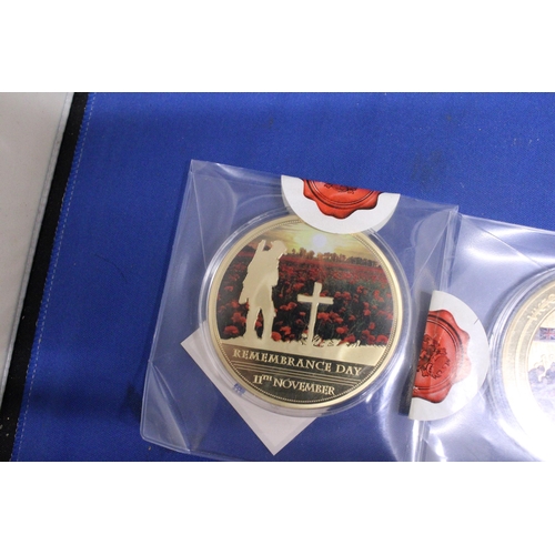 488 - THREE LARGE GOLD PLATED COMMEMORATIVE COINS TO INCLUDE A REMEMBERANCE DAY, AN ARMISTICE AND A VE DAY... 