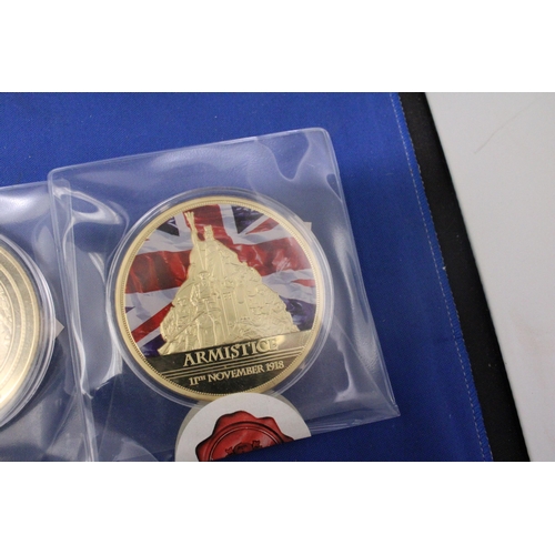 488 - THREE LARGE GOLD PLATED COMMEMORATIVE COINS TO INCLUDE A REMEMBERANCE DAY, AN ARMISTICE AND A VE DAY... 