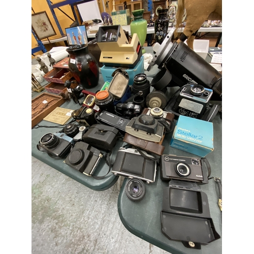 167 - A LARGE LOT OF VINTAGE CAMERAS AND LENSES