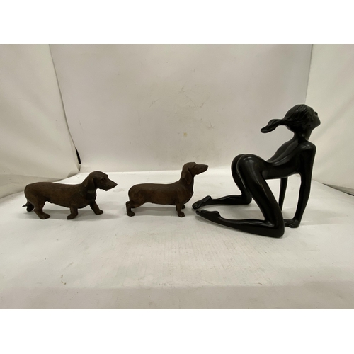 169 - TWO MODELS OF DASCHUND DOGS PLUS A NUDE LADY