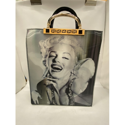 195 - AN AS NEW LADIES PVC BAG WITH A HOLOGRAPHIC IMAGE OF MARILYN MONROE