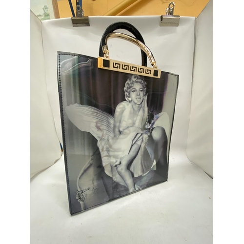 195 - AN AS NEW LADIES PVC BAG WITH A HOLOGRAPHIC IMAGE OF MARILYN MONROE