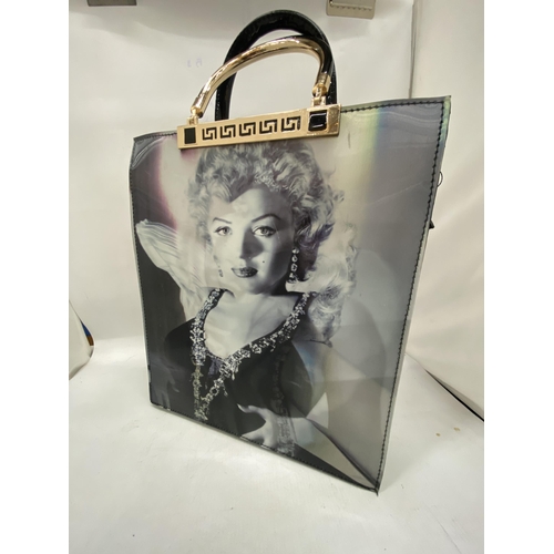 195 - AN AS NEW LADIES PVC BAG WITH A HOLOGRAPHIC IMAGE OF MARILYN MONROE