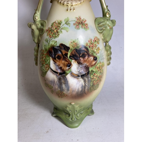 22 - A PAIR OF ANTIQUE VASES WITH TWIN HANDLES IN THE SHAPE OF GOATS DEPICTING SCHNAUZER DOGS - 30.5 CM