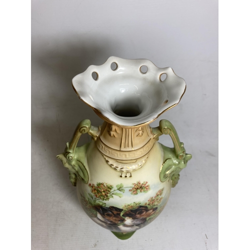 22 - A PAIR OF ANTIQUE VASES WITH TWIN HANDLES IN THE SHAPE OF GOATS DEPICTING SCHNAUZER DOGS - 30.5 CM