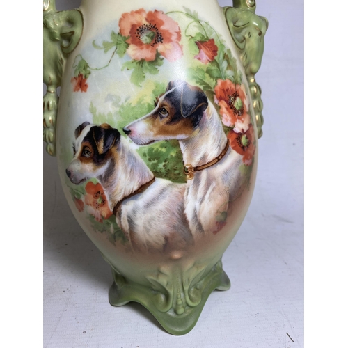 22 - A PAIR OF ANTIQUE VASES WITH TWIN HANDLES IN THE SHAPE OF GOATS DEPICTING SCHNAUZER DOGS - 30.5 CM