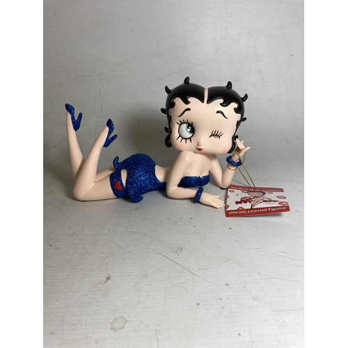 23 - A BETTY BOOP FIGURE LYING DOWN IN A BLUE GLITTER DRESS - 13 CM (H) 20.5 CM (L)