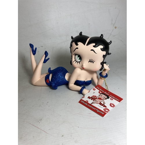 23 - A BETTY BOOP FIGURE LYING DOWN IN A BLUE GLITTER DRESS - 13 CM (H) 20.5 CM (L)