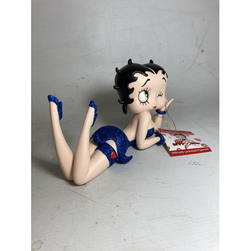 23 - A BETTY BOOP FIGURE LYING DOWN IN A BLUE GLITTER DRESS - 13 CM (H) 20.5 CM (L)