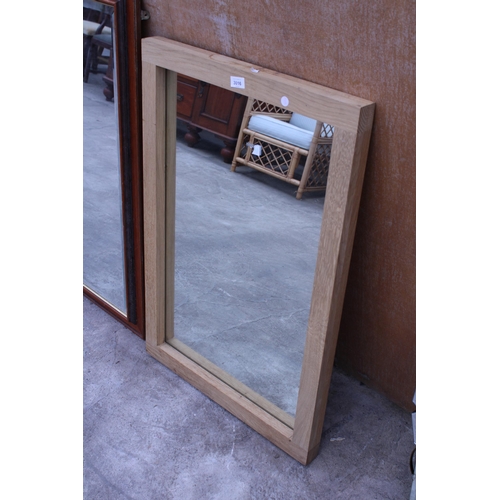 3016 - AN OAK FRAMED WALL MIRROR, 35