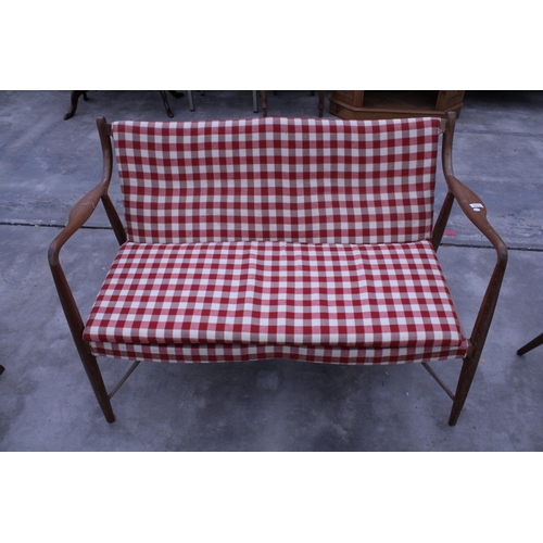 2913 - A RETRO TEAK DANISH STYLE TWO SEATER SETTEE WITH SHAPED OPEN ARMS