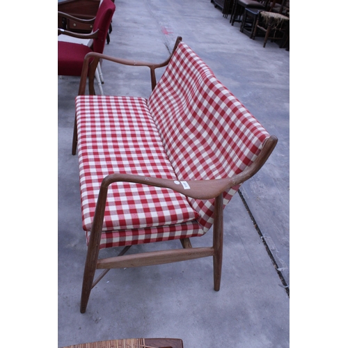 2913 - A RETRO TEAK DANISH STYLE TWO SEATER SETTEE WITH SHAPED OPEN ARMS