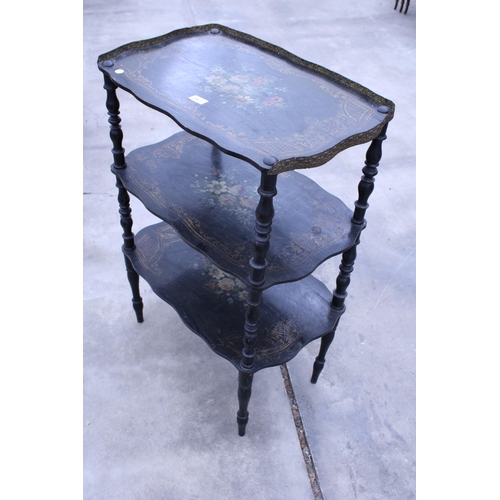 2917 - A VICTORIAN STYLE THREE TIER BLACK PAINTED WHAT NOT WITH FLORAL PAINTED DECORATION AND EMBOSSED BRAS... 