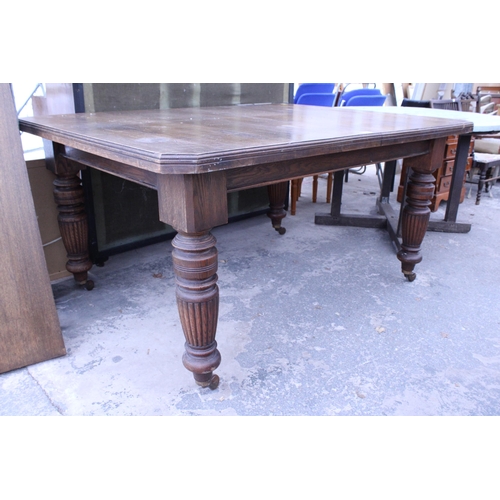 2940 - A LATE VICTORIAN OAK WIND-OUT DINING TABLE ON TURNED LEGS WITH CANTED CORNERS, 57