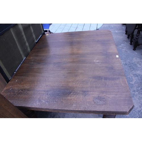 2940 - A LATE VICTORIAN OAK WIND-OUT DINING TABLE ON TURNED LEGS WITH CANTED CORNERS, 57