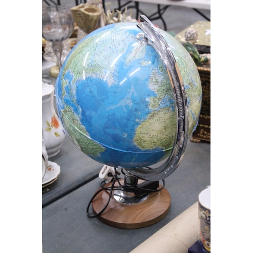 279 - AN ILLUMINATED WORLD GLOBE ON A WOODEN BASE - WORKING AT TIME OF CATALOGUING, NO WARRANTY GIVEN