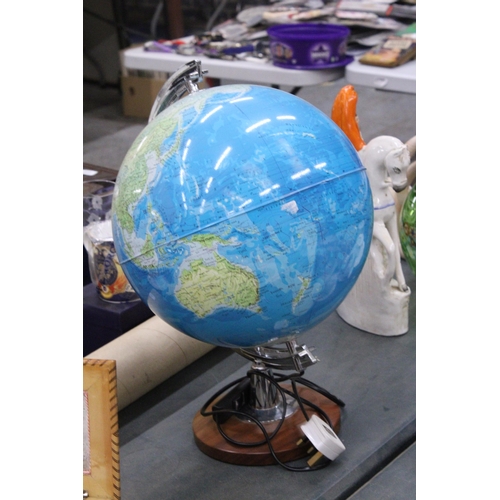 279 - AN ILLUMINATED WORLD GLOBE ON A WOODEN BASE - WORKING AT TIME OF CATALOGUING, NO WARRANTY GIVEN