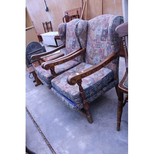 3026 - A PAIR OF VINTAGE OAK AND BEECH FRAMED WINGED FIRESIDE ARMCHAIRS