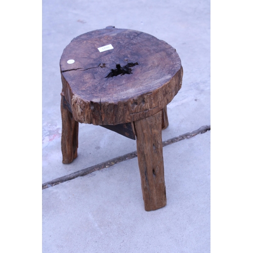 3021 - A VINTAGE LIVE EDGE THREE LEGGED STOOL, 15