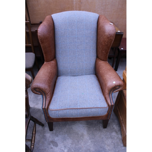 3024 - A MODERN TETRAD LEATHER AND TWEED WINGED EASY CHAIR ON TAPERING LEGS