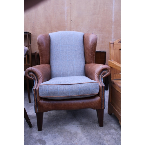 3024 - A MODERN TETRAD LEATHER AND TWEED WINGED EASY CHAIR ON TAPERING LEGS