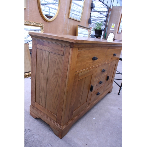 3050 - A MODERN OAK SIDEBOARD ENCLOSING FIVE DRAWERS AND TWO CUPBOARDS 56