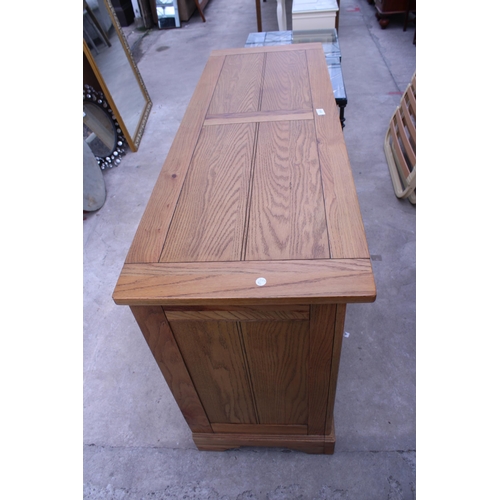 3050 - A MODERN OAK SIDEBOARD ENCLOSING FIVE DRAWERS AND TWO CUPBOARDS 56