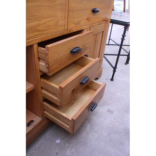 3050 - A MODERN OAK SIDEBOARD ENCLOSING FIVE DRAWERS AND TWO CUPBOARDS 56