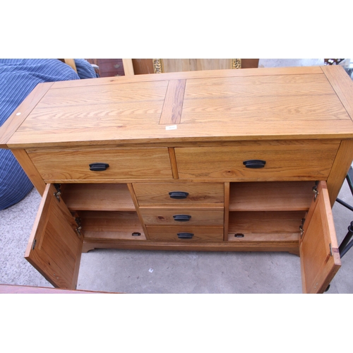 3050 - A MODERN OAK SIDEBOARD ENCLOSING FIVE DRAWERS AND TWO CUPBOARDS 56