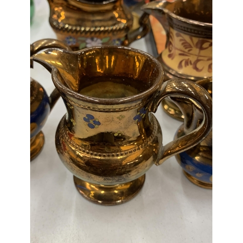 146 - SIX COPPER LUSTRE CERAMIC JUGS, A WALL PLAQUE SIGNED TO THE BACK, PLUS A GOLD COLOURED CERAMIC VASE,... 