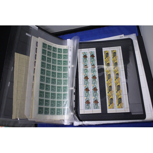 453 - A COLLECTION OF FULL AND PART SHEETS OF WORLD STAMPS IN A RED BINDER