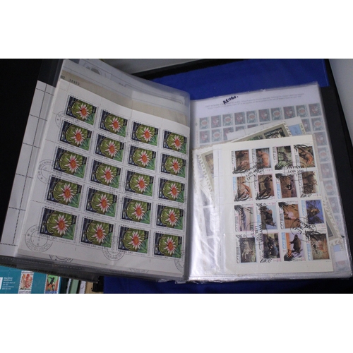 453 - A COLLECTION OF FULL AND PART SHEETS OF WORLD STAMPS IN A RED BINDER