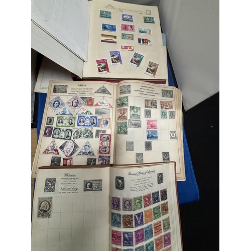 515 - FOUR PART FILLED STAMP ALBUM WITH STAMPS FROM AROUND THE WORLD