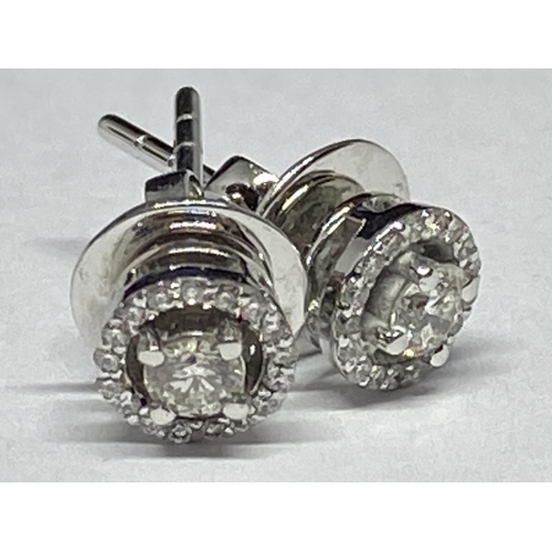 608 - A PAIR OF 18 CARAT WHITE GOLD EARRINGS WITH 0.3 CARATS OF ROUND BRILLIANT CUT NATURAL DIAMONDS GROSS... 