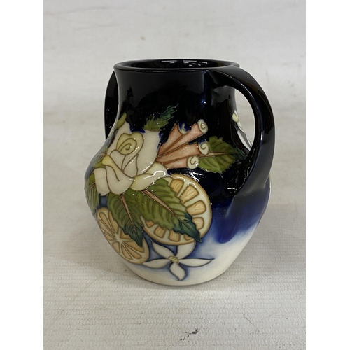 809 - A MOORCROFT TWIN HANDLED VASE AMPULLA PATTERN (N. SLAVEY)