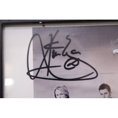 880 - A SIGNED FRAMED PHOTOGRAPH OF WESTLIFE - NO PROVENANCE