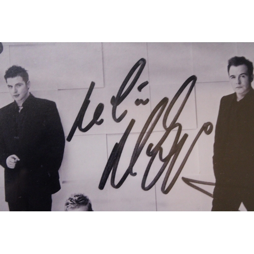 880 - A SIGNED FRAMED PHOTOGRAPH OF WESTLIFE - NO PROVENANCE